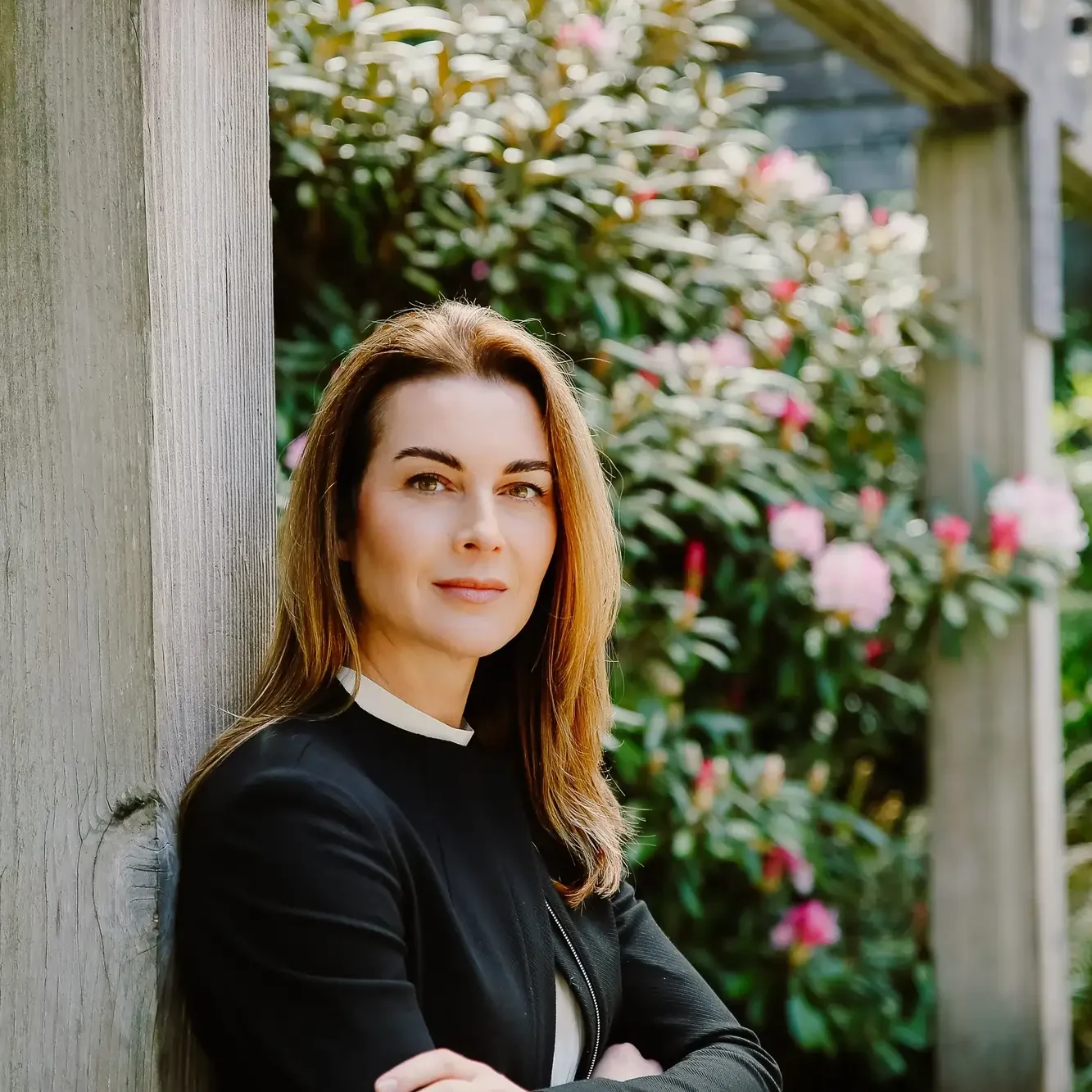 a woman leaning against a wall